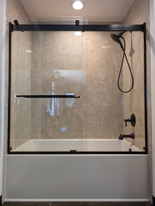 Acrylic wall panels as a tub surround with glass shower door.