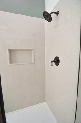 Smooth solid surface shower walls are easy to wipe clean
