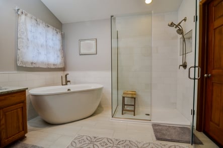 Natural stone tiles serve as a shower and tub surround